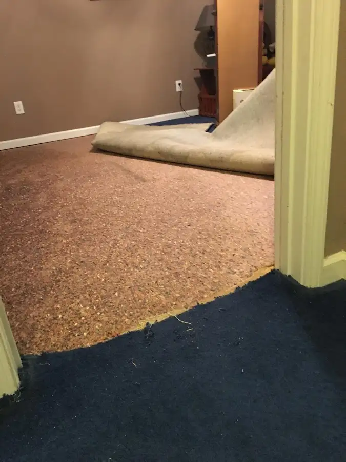 Carpet pad removal revealing water damage during Water Mitigation Services in Fountain Valley