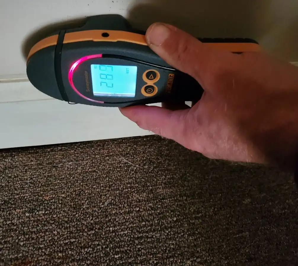 Moisture detection at baseboard during Storm Damage Restoration in Fountain Valley